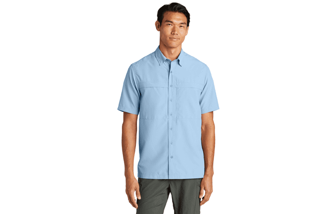 man wearing moisture-wicking performance shirt with buttons, light blue